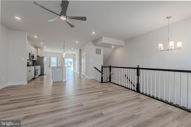 35416 Wright Way, Millsboro, DE 19966 - unfurnished living room with recessed lighting, light wood finished floors, visible vents, baseboards, and ceiling fan with notable chandelier