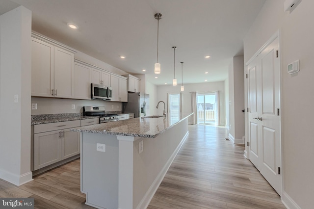 35416 Wright Way, Millsboro, DE 19966 - kitchen with baseboards, appliances with stainless steel finishes, a spacious island, and light wood-type flooring