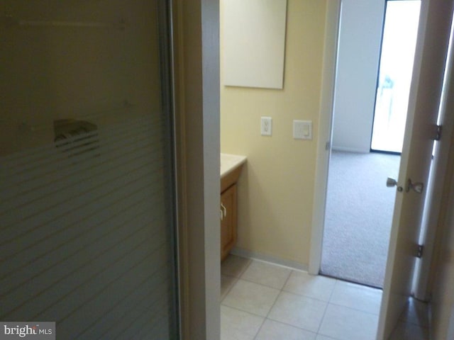 bathroom featuring tile patterned flooring, vanity, and baseboards