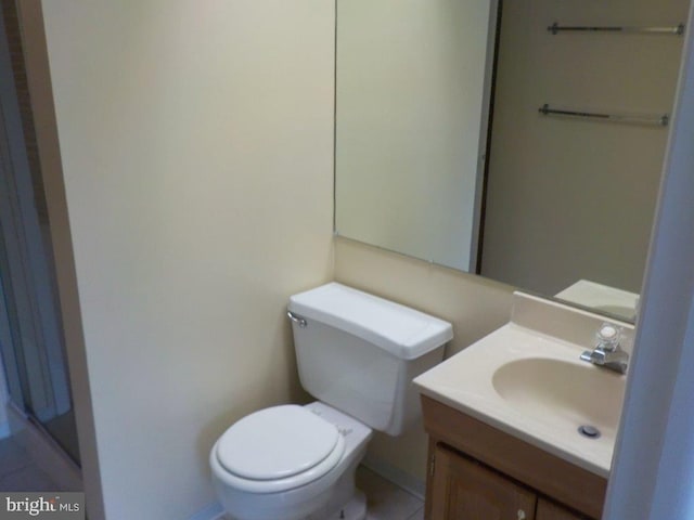 half bathroom with vanity and toilet