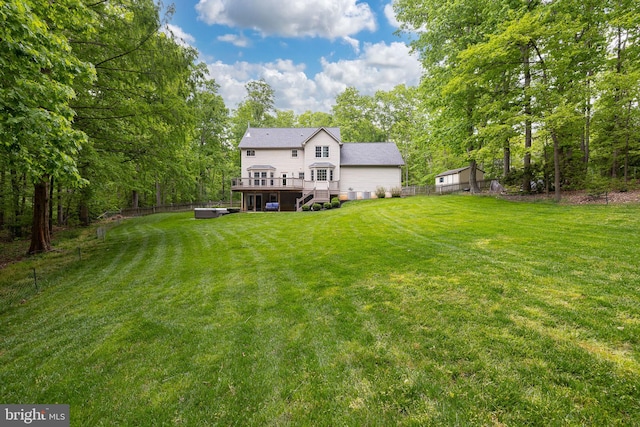 view of yard featuring a deck and fence