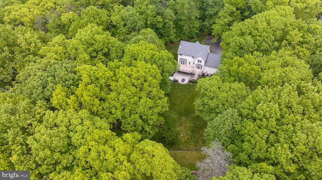 drone / aerial view featuring a wooded view