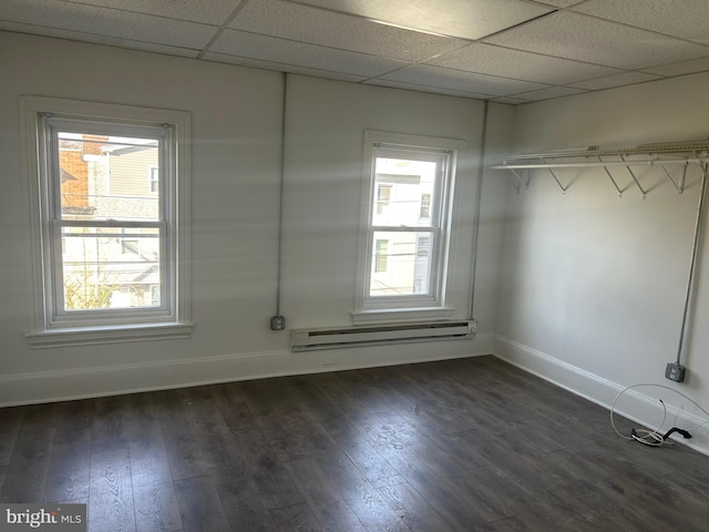 interior space featuring a paneled ceiling, dark wood-style floors, and a baseboard radiator