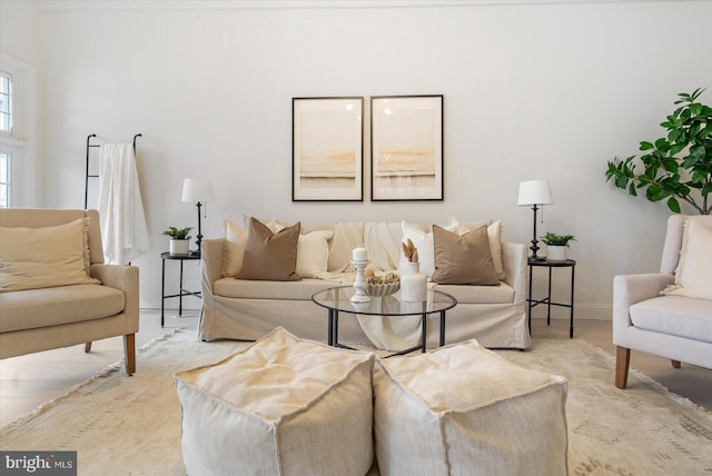 living room with baseboards and light wood-style floors