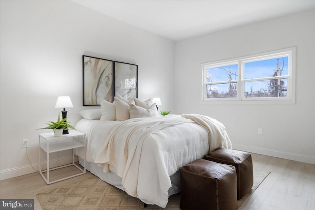 bedroom with baseboards and light wood-style floors