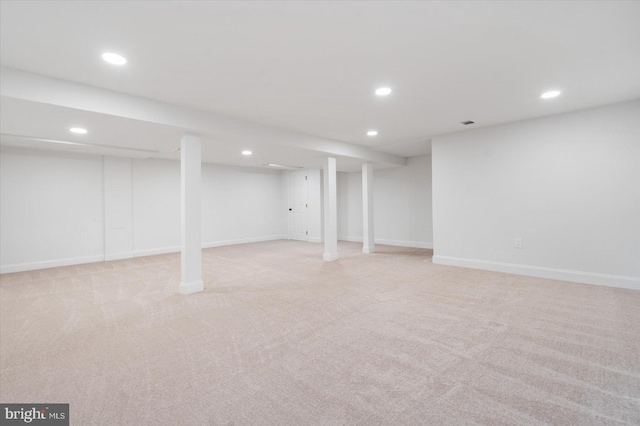 finished below grade area featuring recessed lighting, baseboards, and light carpet