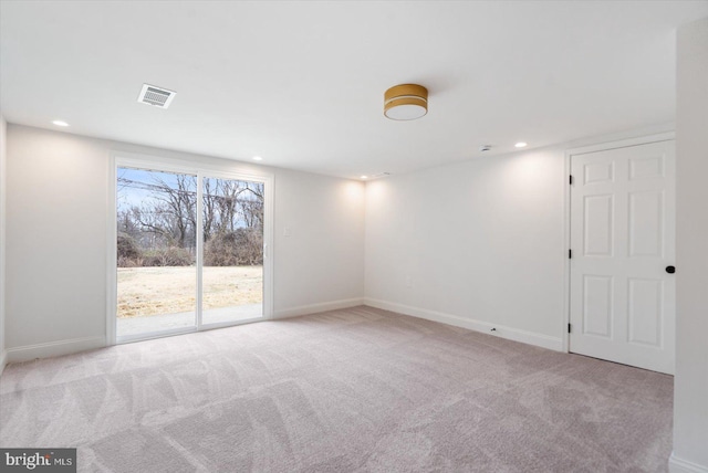 empty room featuring visible vents, recessed lighting, baseboards, and carpet