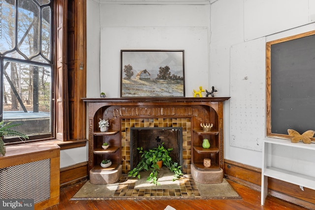 sitting room featuring a fireplace and wood finished floors