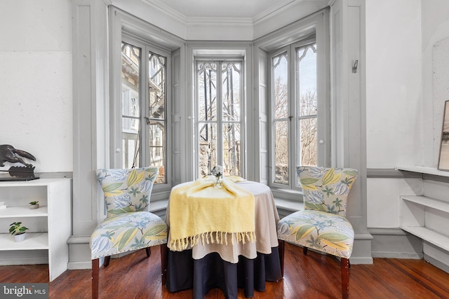 dining room with crown molding and wood finished floors