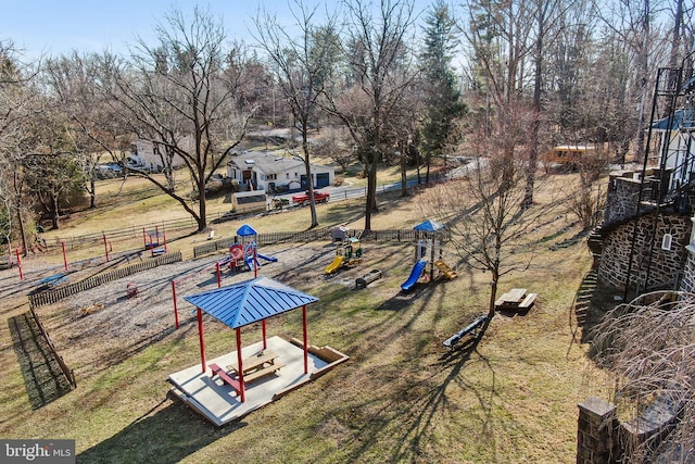 view of yard featuring playground community and fence