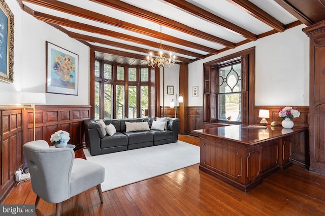 home office with beam ceiling, wainscoting, and a healthy amount of sunlight