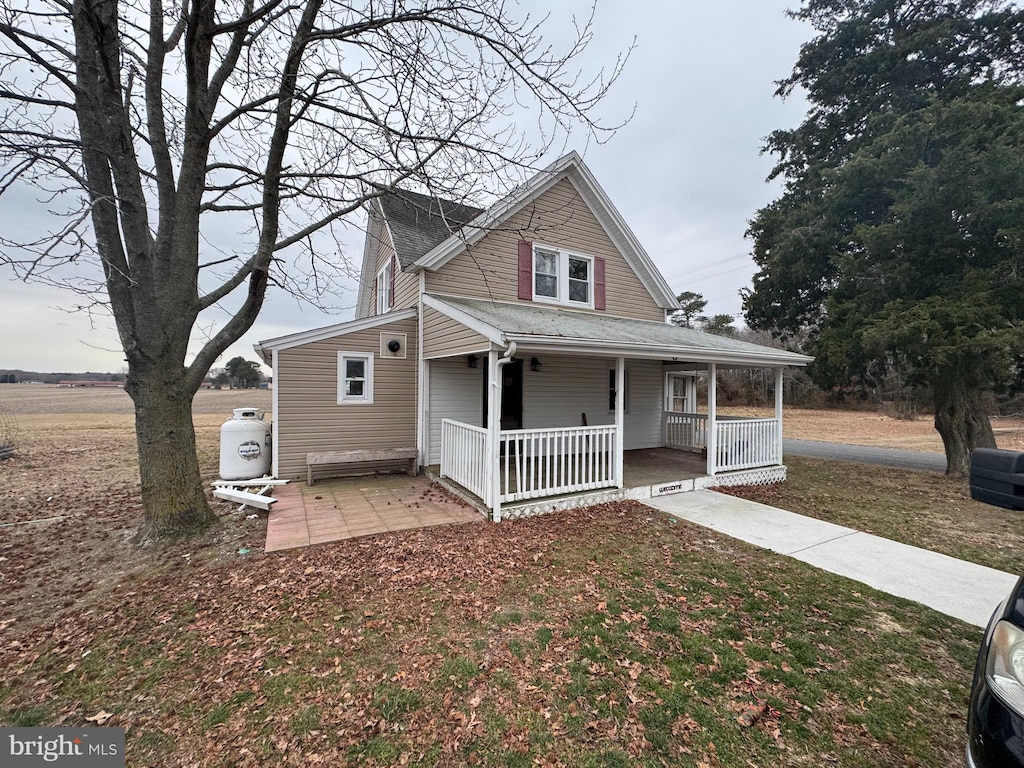 view of front of property with covered porch and roof with shingles