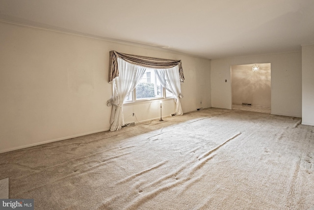 unfurnished room featuring carpet and crown molding