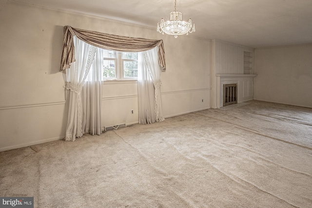 interior space featuring carpet floors, an inviting chandelier, and a fireplace with flush hearth