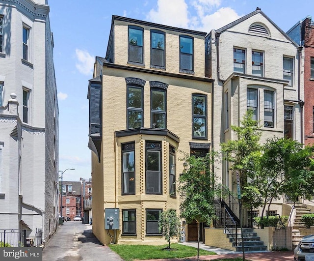 townhome / multi-family property featuring brick siding