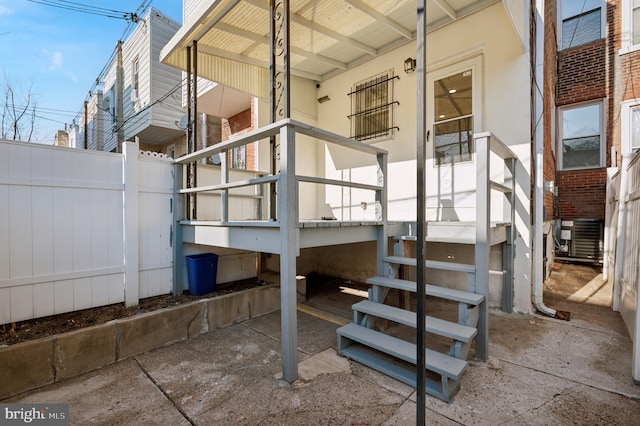 exterior space with a porch, cooling unit, and fence