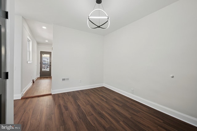 unfurnished dining area featuring recessed lighting, visible vents, baseboards, and dark wood finished floors