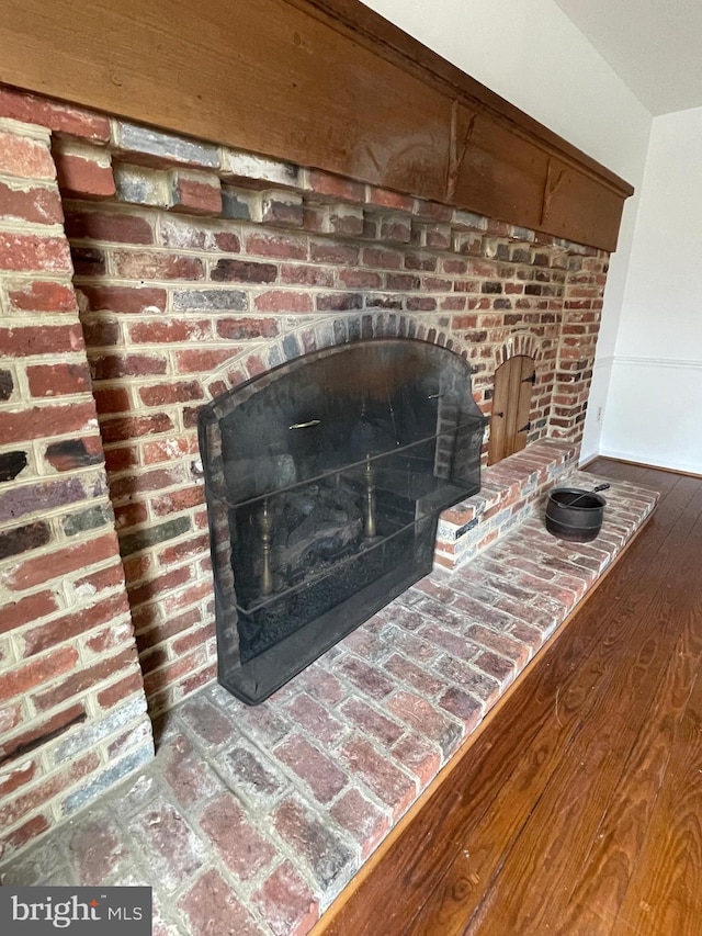 interior details with wood finished floors and a fireplace