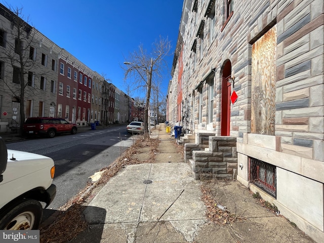 view of road featuring street lights and sidewalks