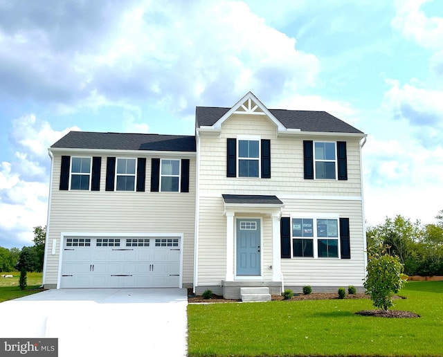 view of front of property with entry steps, driveway, an attached garage, and a front lawn