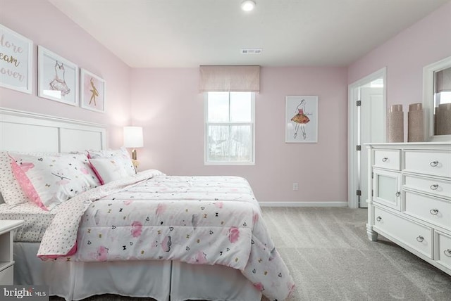 bedroom with light colored carpet, visible vents, and baseboards