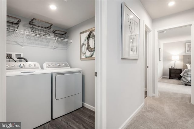 clothes washing area featuring laundry area, separate washer and dryer, baseboards, and carpet floors