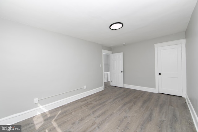 unfurnished bedroom featuring baseboards and wood finished floors