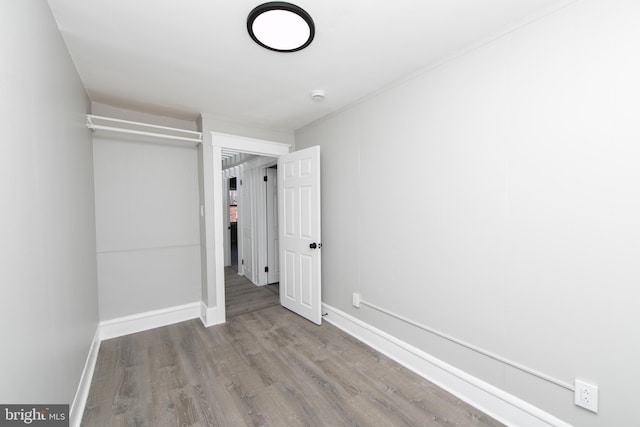 unfurnished bedroom featuring baseboards and wood finished floors