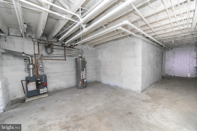 unfinished below grade area with gas water heater and a heating unit