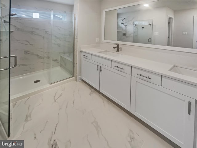 bathroom featuring a sink, a marble finish shower, marble finish floor, and double vanity