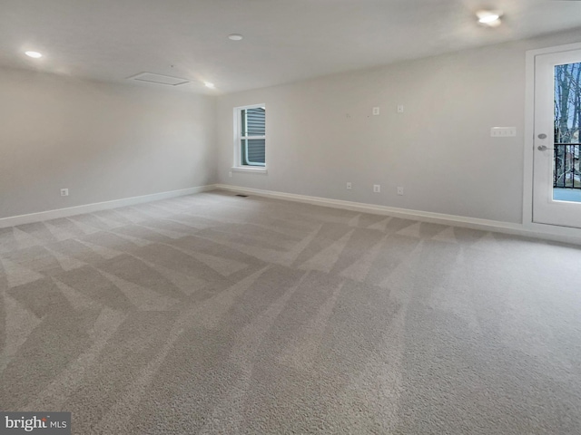 carpeted empty room featuring recessed lighting and baseboards