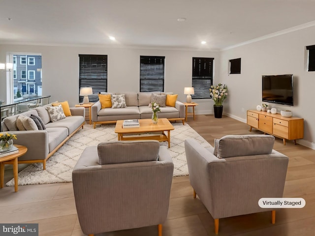 living area with recessed lighting, light wood-style flooring, baseboards, and ornamental molding