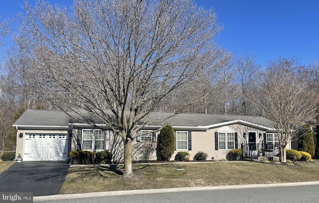 single story home featuring aphalt driveway and an attached garage