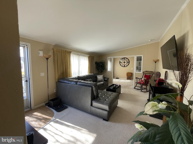 living area featuring vaulted ceiling, light carpet, baseboards, and ornamental molding