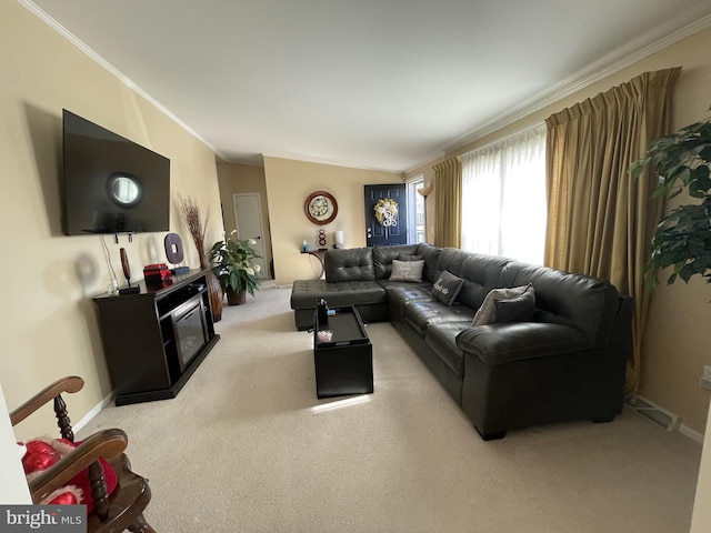 carpeted living area with crown molding and baseboards