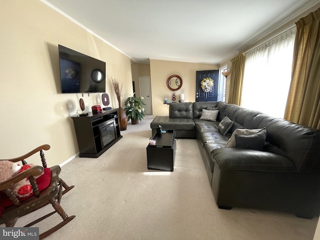 living room featuring carpet flooring, baseboards, a fireplace, and crown molding