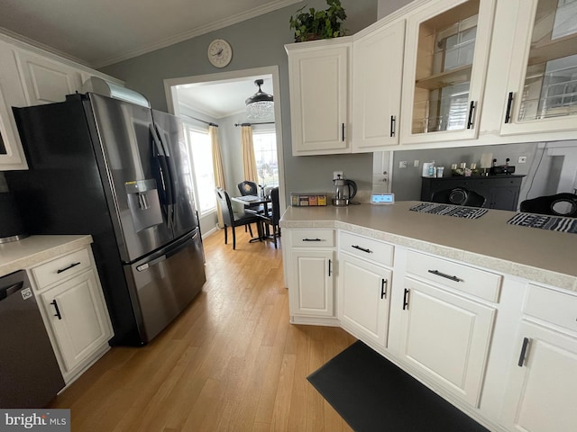 kitchen featuring stainless steel fridge, dishwasher, ornamental molding, and white cabinetry