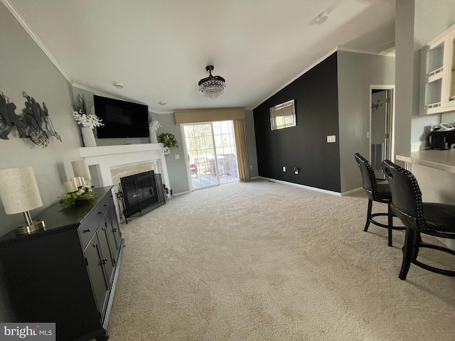 living area featuring a high end fireplace, light colored carpet, crown molding, and baseboards