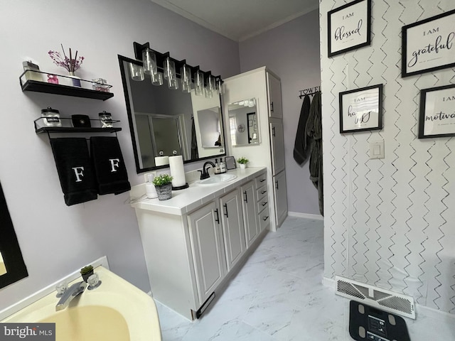 bathroom with vanity, visible vents, baseboards, crown molding, and marble finish floor