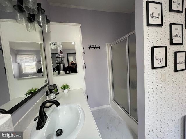 full bathroom with an accent wall, baseboards, a stall shower, marble finish floor, and vanity