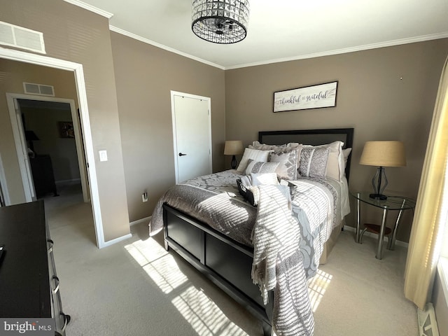 bedroom with visible vents, crown molding, and carpet floors