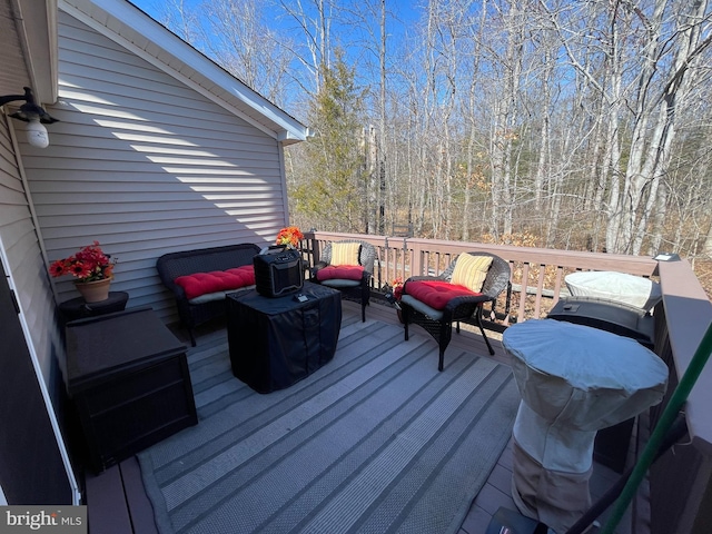 wooden terrace with a wooded view