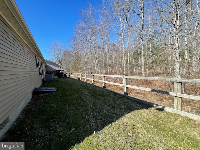 view of yard with fence and central AC