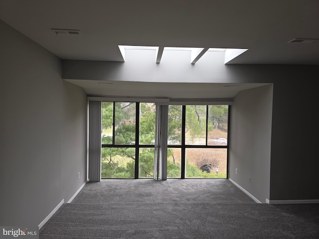 carpeted spare room featuring visible vents and baseboards