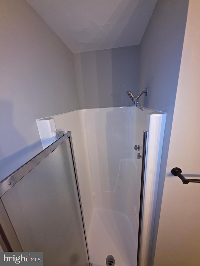 full bath featuring a shower stall