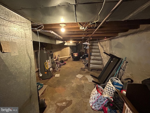 unfinished basement featuring gas water heater and stairway