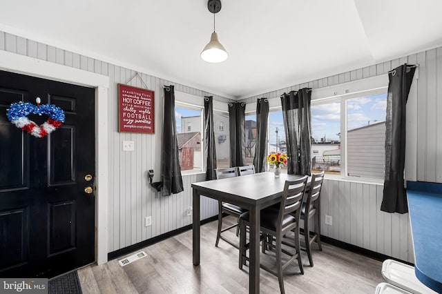 dining area featuring visible vents, baseboards, and light wood-style floors