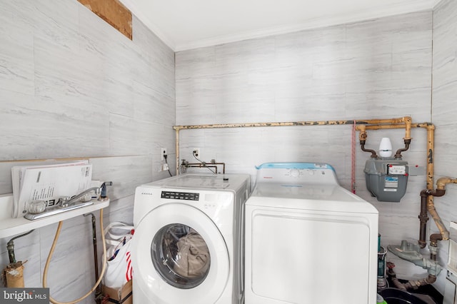 laundry room featuring crown molding, laundry area, and washing machine and clothes dryer