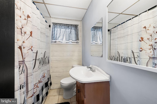 bathroom with tile patterned floors, a shower with shower curtain, toilet, and vanity