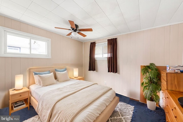 bedroom with multiple windows and a ceiling fan